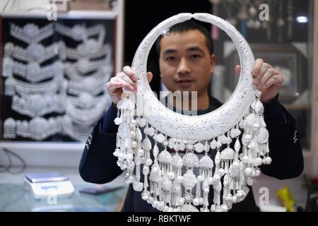 Qiandongnan. 11th Jan, 2019. A craftsman displays a silver accessory in Kaili City, southwest China's Guizhou Province, Jan. 10, 2019. People are busy making silver handicrafts for the upcoming Spring Festival, which starts from the first day of the first month of the Chinese lunar calendar, or Feb. 5 this year. Credit: Xinhua/Alamy Live News Stock Photo