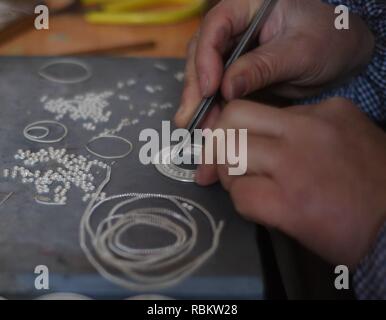 Qiandongnan. 11th Jan, 2019. A silver handicraft artisan makes silver accessories in Kaili City, southwest China's Guizhou Province, Jan. 10, 2019. People are busy making silver handicrafts for the upcoming Spring Festival, which starts from the first day of the first month of the Chinese lunar calendar, or Feb. 5 this year. Credit: Xinhua/Alamy Live News Stock Photo