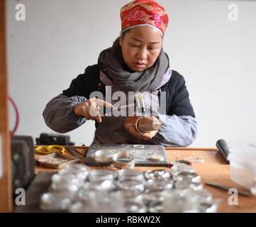 Qiandongnan. 11th Jan, 2019. A craftswoman makes silver accessories in Kaili City, southwest China's Guizhou Province, Jan. 10, 2019. People are busy making silver handicrafts for the upcoming Spring Festival, which starts from the first day of the first month of the Chinese lunar calendar, or Feb. 5 this year. Credit: Xinhua/Alamy Live News Stock Photo