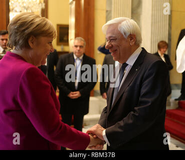 Athens, Greece. 11th Jan, 2019. Greek President Prokopis Pavlopoulos (R) shakes hands with German Chancellor Angela Merkel at the Presidential Mansion in Athens, Greece, on Jan. 11, 2019. Germany's support to Greece during the difficult bailout period from 2010 until August 2018, as well as in the post-bailout era, is support to the EU's cohesion, Greek President Prokopis Pavlopoulos said on Friday, welcoming German Chancellor Angela Merkel to Athens. Credit: Marios Lolos/Xinhua/Alamy Live News Stock Photo