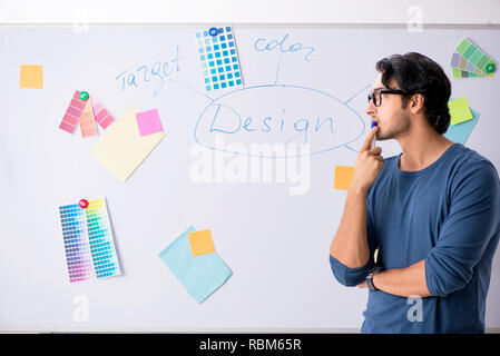 Young handsome designer working at the project Stock Photo