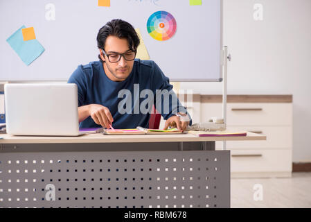Young handsome designer working at the project Stock Photo