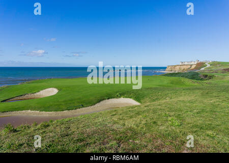 Golf course putting green on the cliffs by the pacific ocean, Resort in the background, Half Moon Bay, California Stock Photo