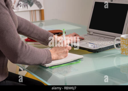 Details of woman hands working and studying at home with e-learning concept Stock Photo