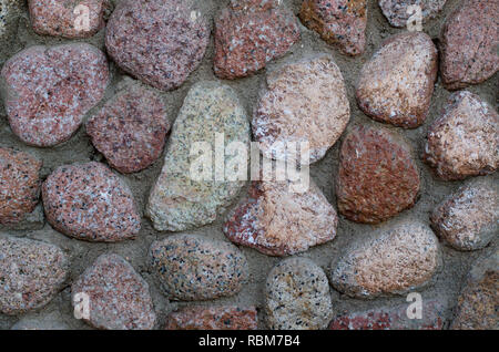 Beige and pink stones at the wall. Stone texture background. Stock Photo