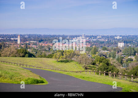 Paved running trail on the Standford dish surrounding hills; Stanford campus, Palo Alto and Silicon Valley skyline in the background, San Francisco ba Stock Photo