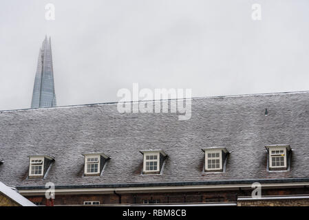Snow in London. The roofs of Tower of London covered in fresh white snow. In the background the Shard, the tallest skyscraper in Europe. Stock Photo