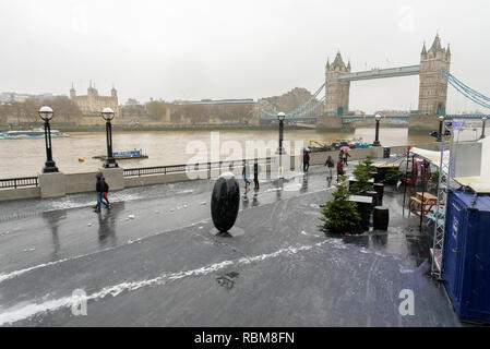 Snow at London Bridge City riverside on the Thames. Tower Bridge in the background Stock Photo