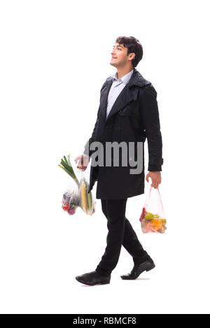 Young handsome man with vegatables in shopping concept Stock Photo