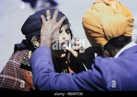 Roadside dentist checking teeth of women, Pushkar Fair, Rajasthan, India, Asia Stock Photo