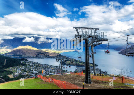 Cable car lift for luge riders and view of Wakatipu lake and Queenstown in New Zealand