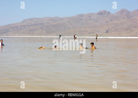 People are swimming in the salt Urmia Lake, West Azerbaijan province, Iran Stock Photo