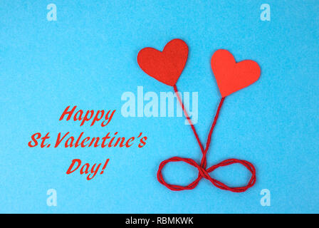 Two felt hearts on a blue background. Stock Photo