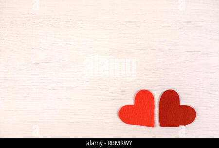 Two felt hearts on a wooden background. Stock Photo