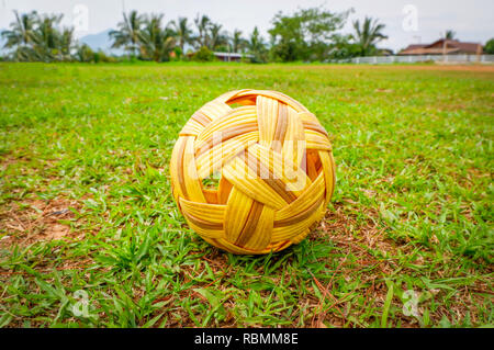Sepak Takraw ball - rattan ball sport outdoor / Sepak takraw on green grass field Stock Photo