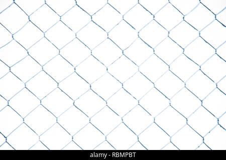 Wire fence in the snow. Fence background. Metallic net with snow. Metal net in winter covered with snow. Wire fence closeup. Steel wire mesh fence vin Stock Photo