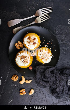 baked apples with nuts and honey, desert on plate Stock Photo
