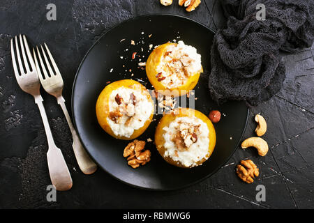 baked apples with nuts and honey, desert on plate Stock Photo