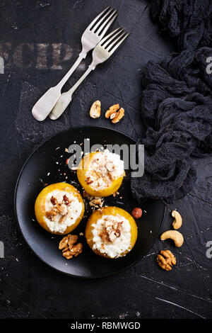 baked apples with nuts and honey, desert on plate Stock Photo