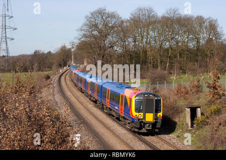 A pair of class 450 Desiro electric multiple units numbers 450113 and 450002 forming a South West Trains service near Chertsey in Surrey. Stock Photo