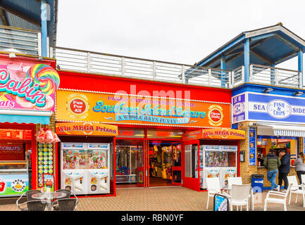 Brightly coloured red slot machine in amusement arcade in Sandown Pier ...