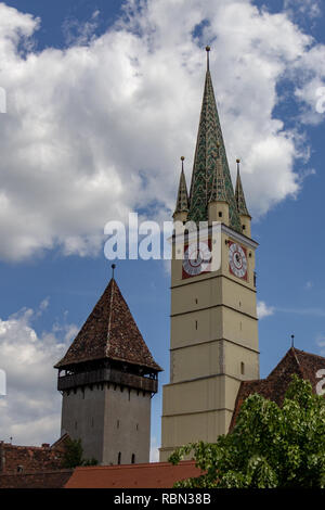 In Medias, Romania the Bell and Trumpet Towers dominate the skyline near the main square Stock Photo