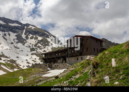 A lodge sits on the shores of Balea Lake in Romania Stock Photo