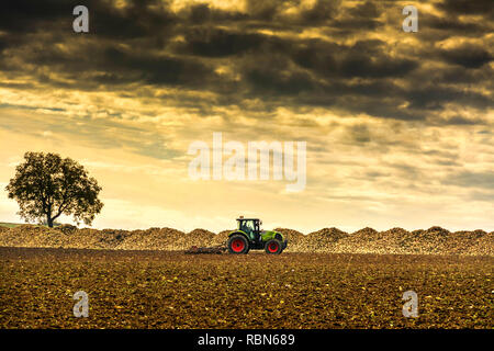 Tractor in a filed, Puy de Dome department, Auvergne Rhone Alpes, France, Europe Stock Photo