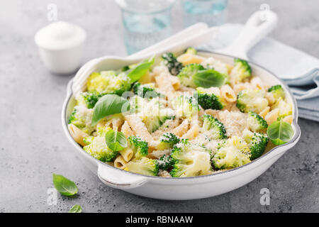 Tasty fresh pasta made with broccoli, basil and cheese served in pan. Concept of healthy food Stock Photo