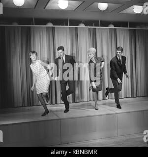 Dancing in the 1960s. The dance Hully Gully is being made popular and here are men and women dancing the new craze. Hully Gully was a type of unstructured line dance and consisted of a series of steps and was relatively simple and easy to execute. Hully Gully can be seen performed by actor John Belushi in the film Blues Brothers. Stock Photo