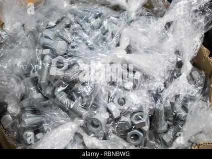 New nuts and bolts in the plastic bag for ready to packing after from the production process. Stock Photo