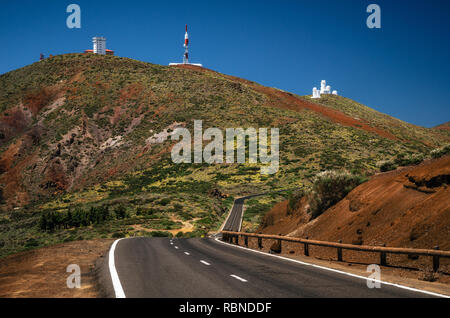 Winding road against Observatory on slopes of Teide volcano in Tenerife Stock Photo