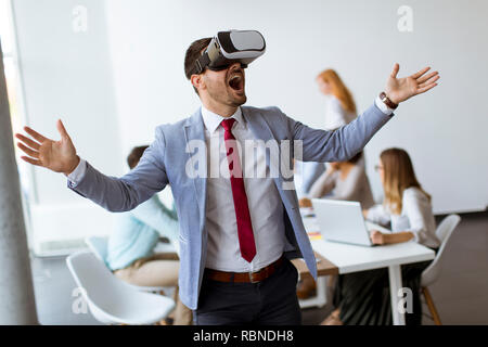 Businessman making team training exercise during team building seminar using VR glasses in office Stock Photo