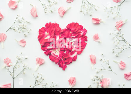 Heart shape made of flowers on white background.Flat lay. Valentines,love and wedding concept ideas Stock Photo