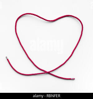 Heart shape from red yarn,rope on blue background.love,wedding,valentine concept ideas Stock Photo