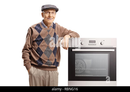 Elderly man standing with an electric oven isolated on white background Stock Photo