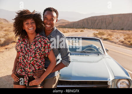 Young black couple on road trip having a roadside stop off Stock Photo