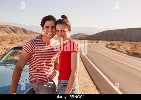 Young white couple on a road trip break looking to camera Stock Photo