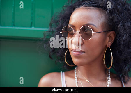Trendy young woman in camisole and sunglasses and jewellery Stock Photo