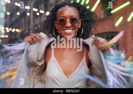 Trendy woman in striped camisole and fringed jacket Stock Photo