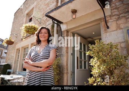 Female restaurant pub owner standing outside her business Stock Photo