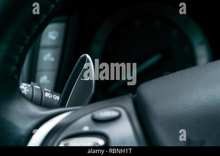 Manual gear changing stick on a car's steering wheel, Modern car interior details Stock Photo