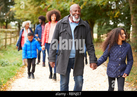 Multi Generation Family On Autumn Walk In Countryside Together