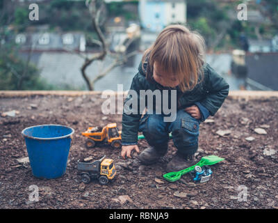 A little toddler is playing outside in winter Stock Photo