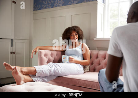Young mixed race couple relax together drinking coffee in the morning, selective focus Stock Photo