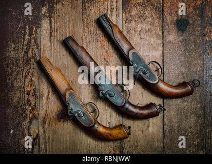 Two vintage pistols on wooden background Stock Photo