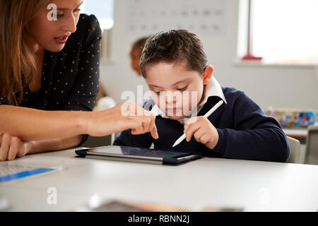 Young Boy Working at Desk in School Stock Photo - Alamy