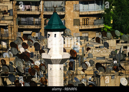 Mosque minar and satelites TV dishes, Aleppo. Syria, Middle East Stock Photo