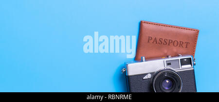 Passport and vintage camera on blue copy space Stock Photo