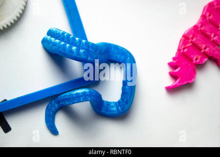 Bright colorful objects printed by a 3d printer close-up. Progressive ...